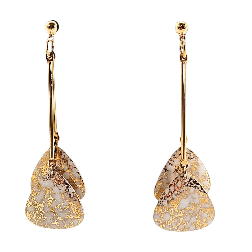 Gold and white floral earrings on a white background