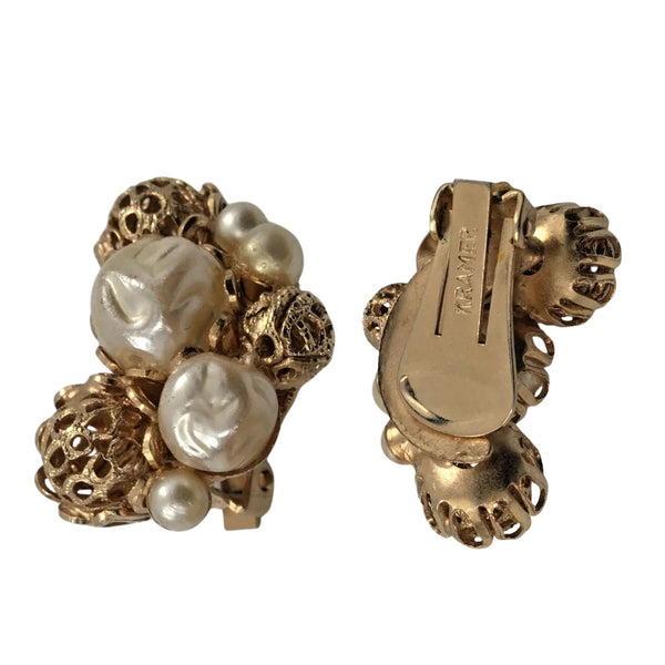Gold earrings with pearls on a white background