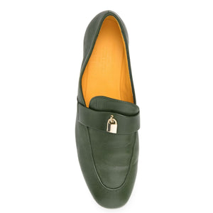 Green loafer shoe with gold buckle on a white background