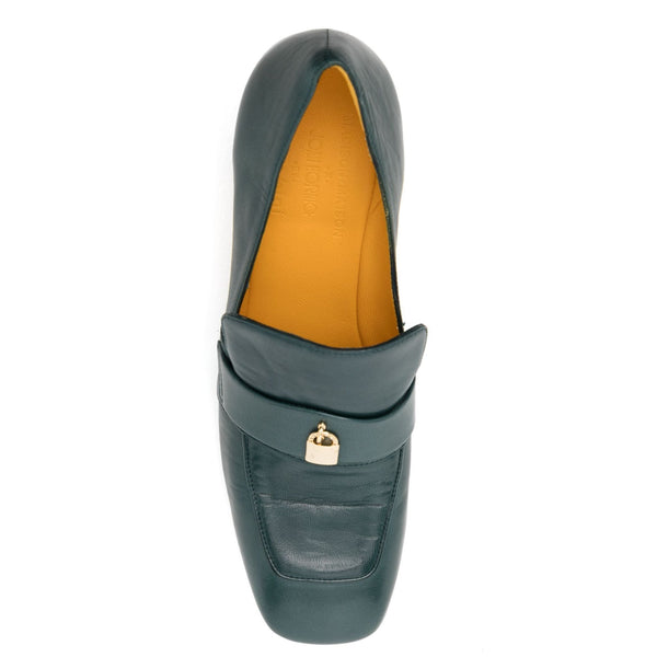 Green loafer shoe with gold lock detail on a white background