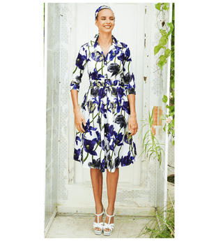 A knee-length dress with a collared neckline, three-quarter sleeves, and a flared skirt. Features a bold allover abstract pattern and fitted waist.