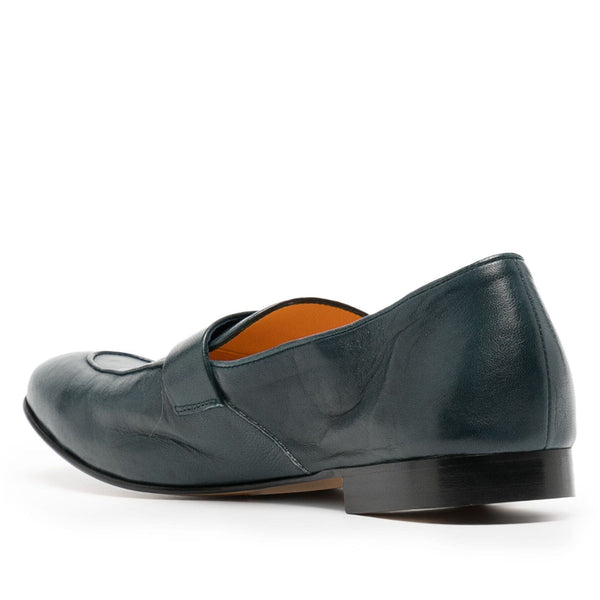 Green leather loafer shoe on a white background