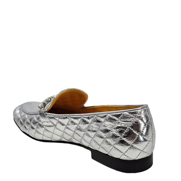 Silver quilted loafers on a white background