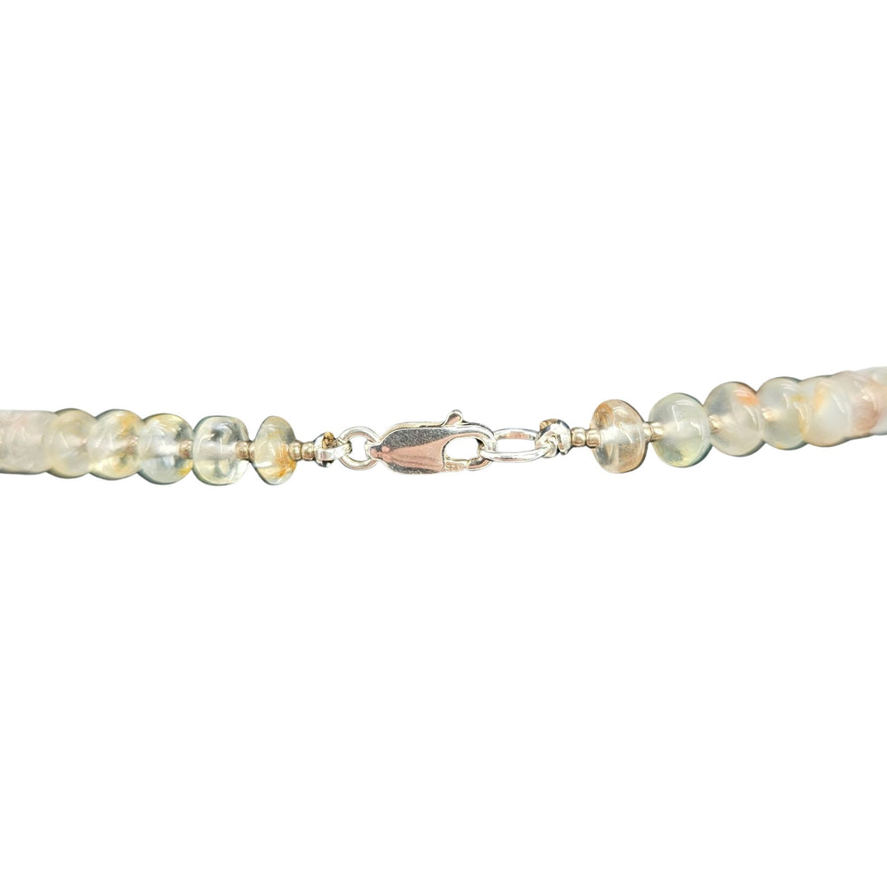Opal-like beaded necklace with small round faceted stones in pale blue and cream