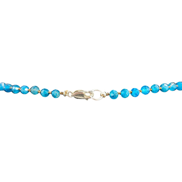Blue beaded bracelet with a clasp on a white background