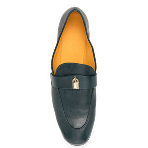 Black loafer shoe with gold buckle on a white background
