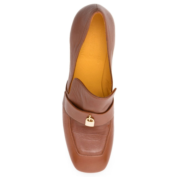 Brown leather loafer with gold lock detail on a white background