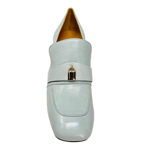 Light blue loafers with a gold buckle on a white background