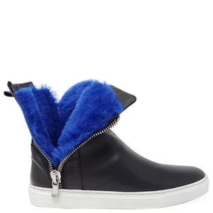 Black ankle boot with blue fur lining and a silver zipper on a white background