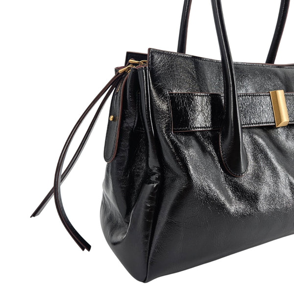 A sleek, black leather handbag with two slender top handles and a horizontal gold bar accent on the front.