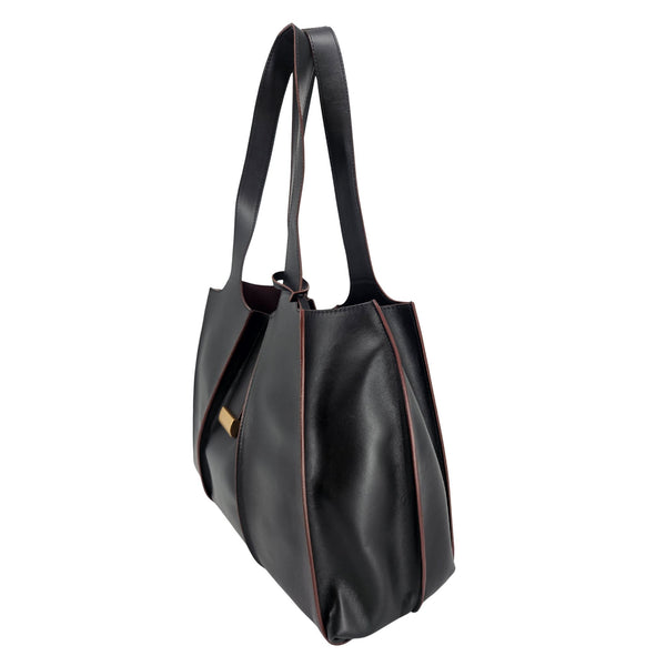 A sleek, black polished leather handbag with a wide opening, two top handles, and a horizontal gold bar accent on the front.
