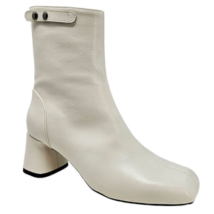 White ankle boot with block heel on a white background