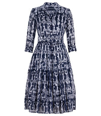 A knee-length dress with a collared neckline, three-quarter sleeves, and a flared skirt. Features a bold allover abstract pattern and fitted waist.
