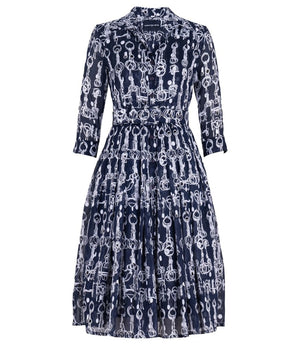 A knee-length dress with a collared neckline, three-quarter sleeves, and a flared skirt. Features a bold allover abstract pattern and fitted waist.