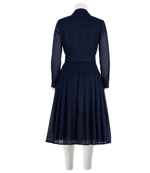 A knee-length dress with a collared neckline, three-quarter sleeves, and a flared skirt. Features a bold allover abstract pattern and fitted waist.