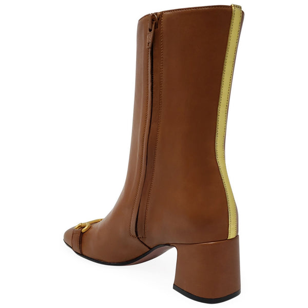 Brown leather boot with yellow trim on a white background