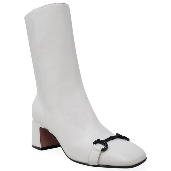 White ankle boot with a black buckle on a white background