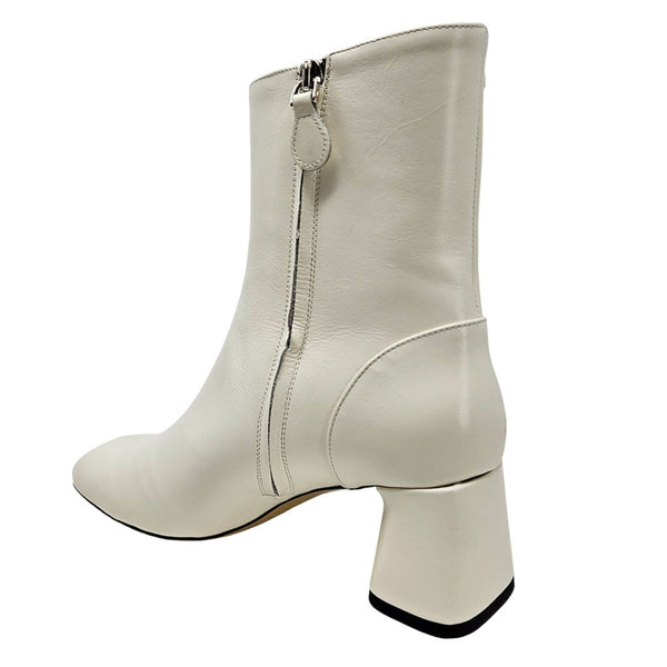 White ankle boot with a block heel on a white background