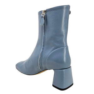 Blue leather boot with a block heel on a white background