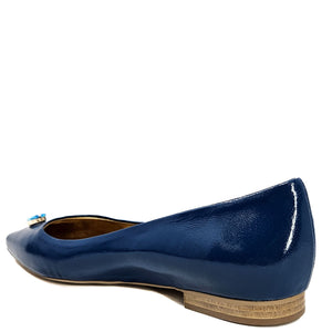 Blue patent leather flat shoe on a white background