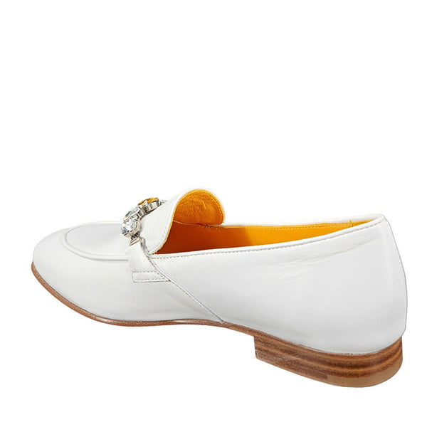 White loafer shoe with a decorative buckle on a white background
