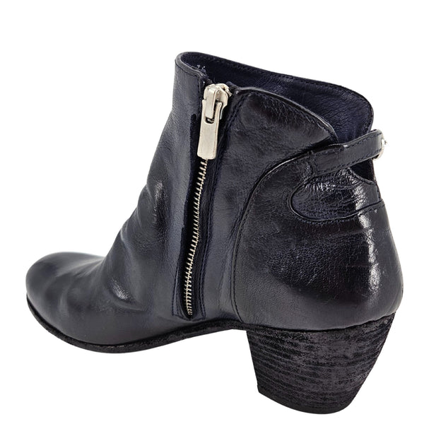Black leather ankle boot with a gold zipper on a white background