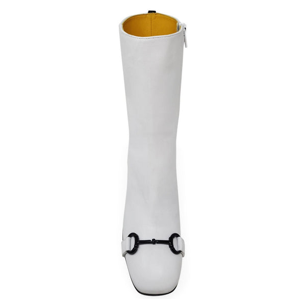 White knee-high boot with a gold interior and black buckle on a white background