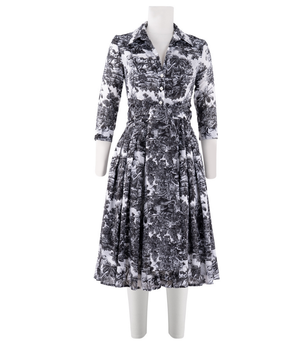 A knee-length dress with a collared neckline, three-quarter sleeves, and a flared skirt. Features a bold allover abstract pattern and fitted waist.
