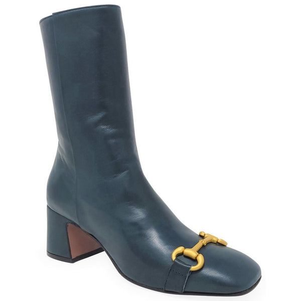 Blue boot with a gold buckle on a white background