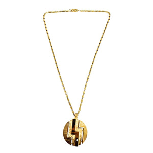 Gold necklace with a round pendant on a white background