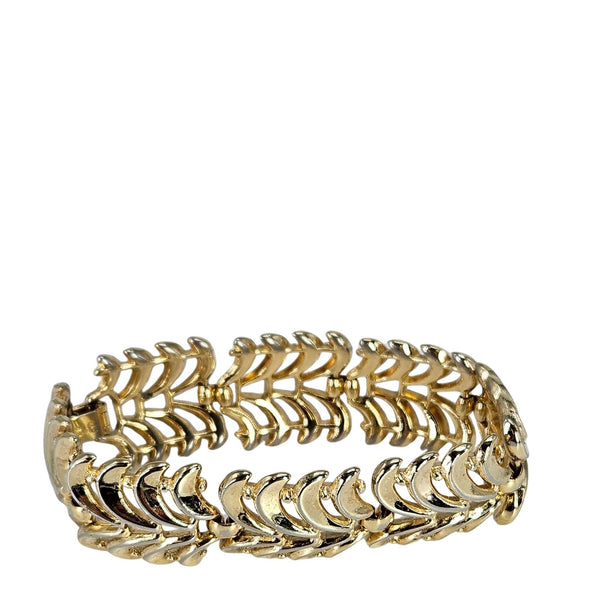 Gold bracelet with leaf-like design on a white background