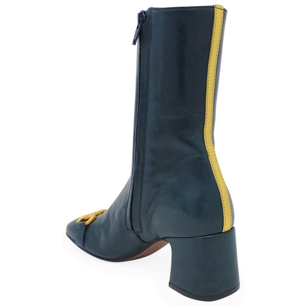 Green boot with yellow trim on a white background