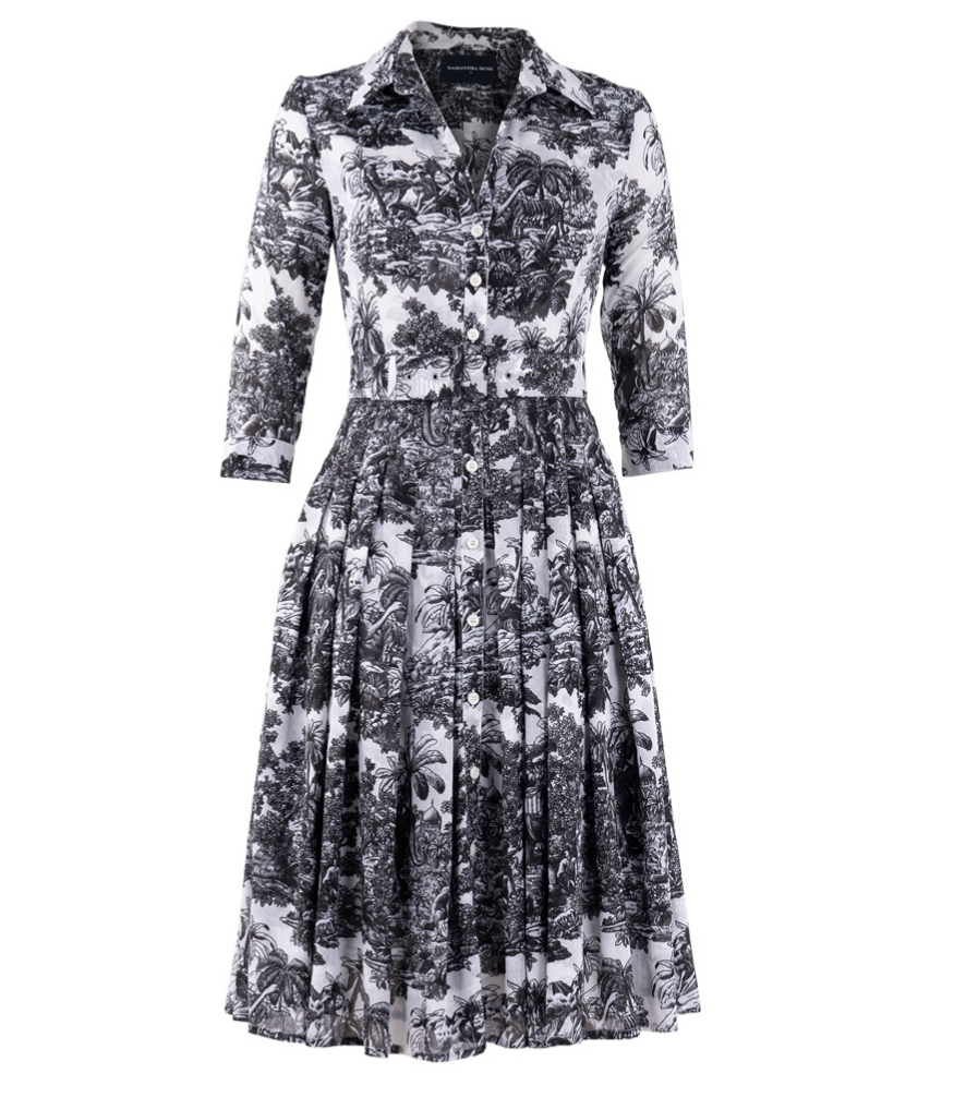 A knee-length dress with a collared neckline, three-quarter sleeves, and a flared skirt. Features a bold allover abstract pattern and fitted waist.