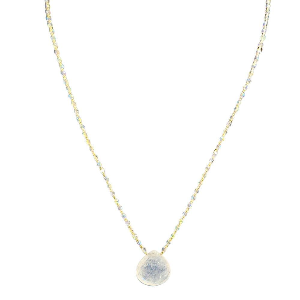 Necklace with a round, textured pendant on a thin chain against a white background