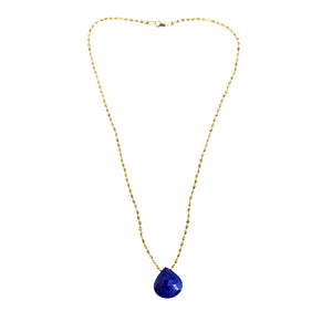 Gold necklace with a blue pendant on a white background