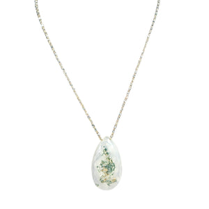 Teardrop-shaped pendant with floral design on a white background