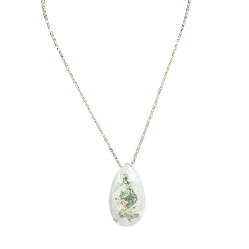 Teardrop-shaped pendant with floral design on a white background