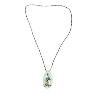 Necklace with a clear pendant on a white background