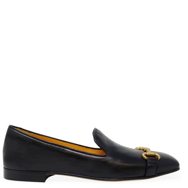 Black loafer with gold buckle on a white background