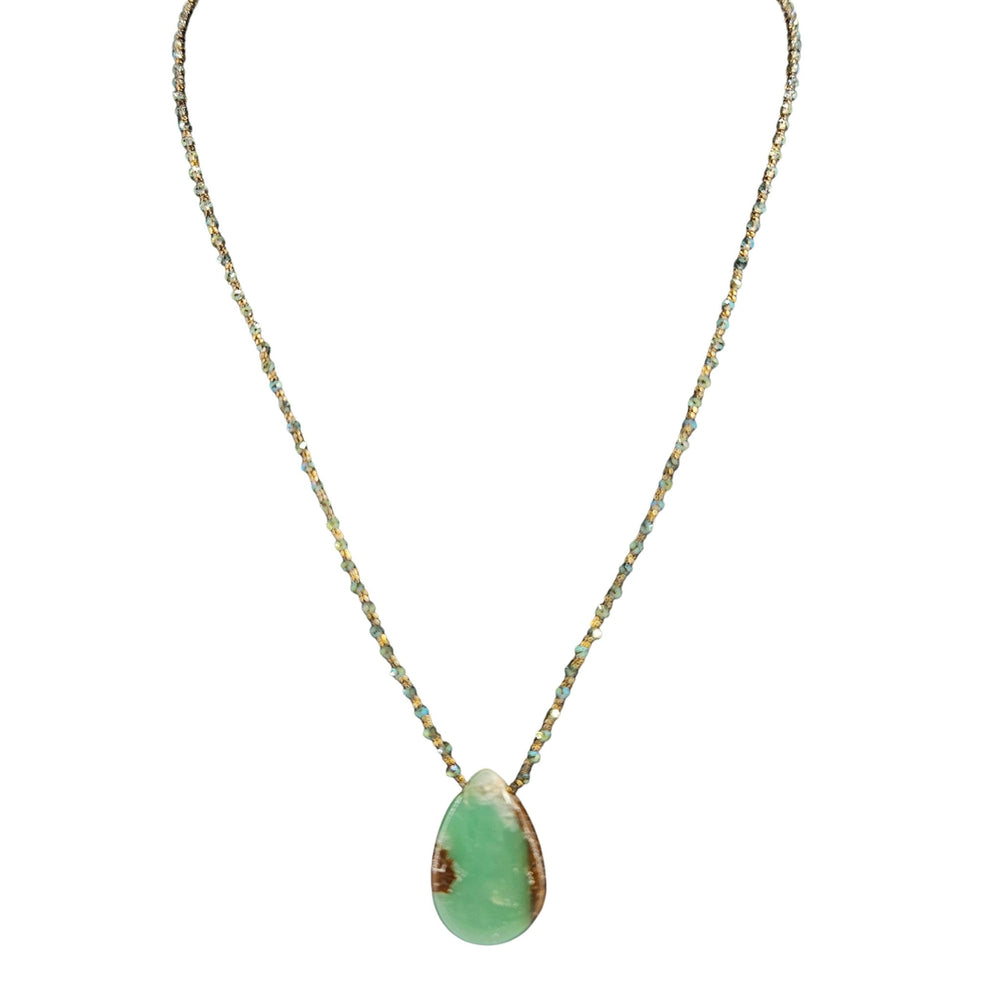Necklace with a green teardrop pendant on a white background