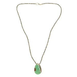 Necklace with a green pendant on a white background