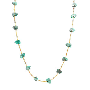 Necklace with green gemstones on a white background