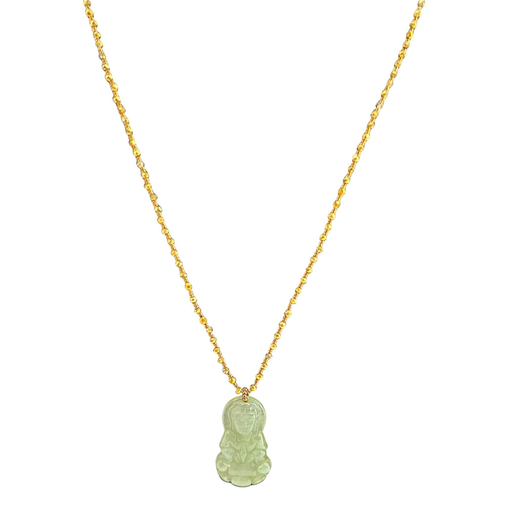 Gold necklace with a green pendant on a white background