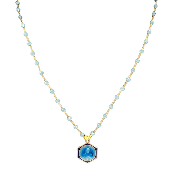 Necklace with blue pendant and gold chain on a white background