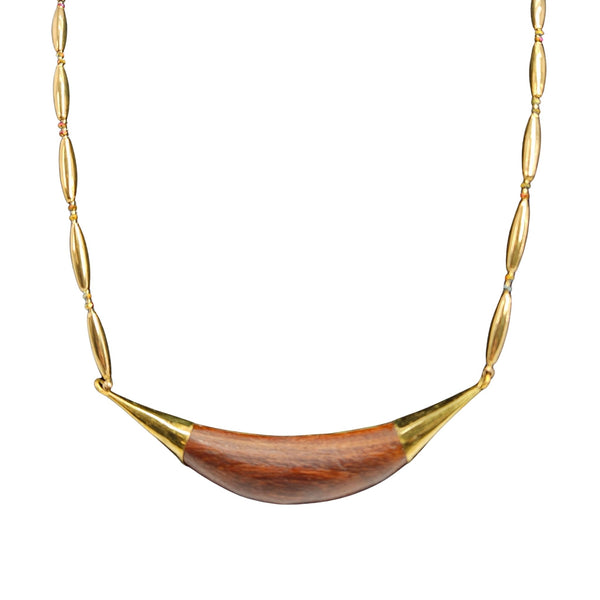 Necklace with a wooden pendant and gold accents on a white background