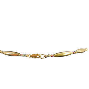 Gold bracelet with colorful beads on a white background
