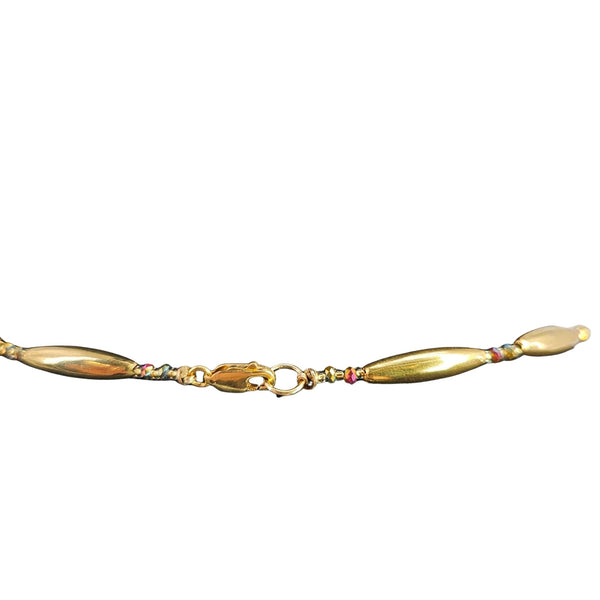 Gold bracelet with colorful beads on a white background