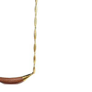 Gold and wooden necklace on a white background