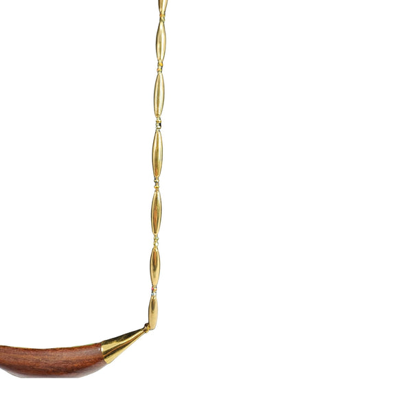 Gold and wooden necklace on a white background