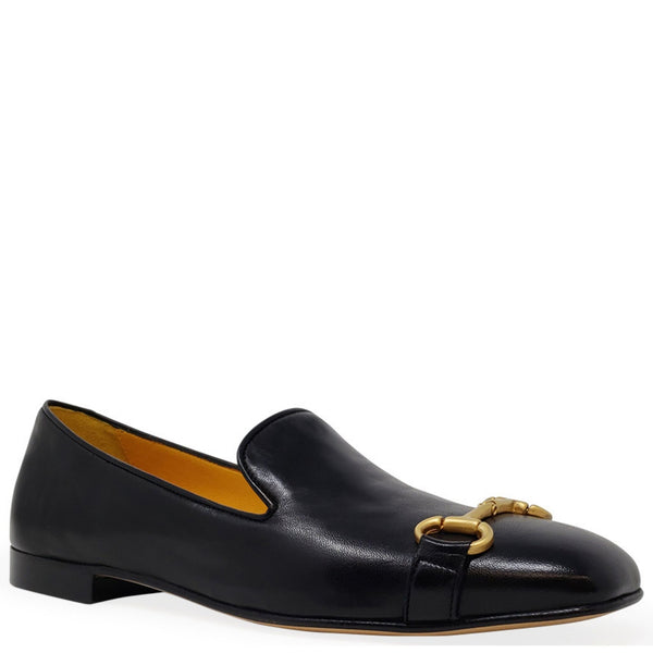 Black loafer with gold buckle on a white background